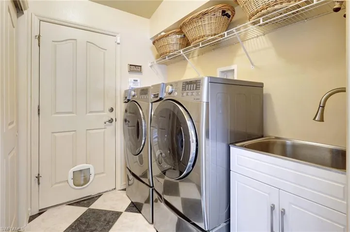 Laundry area with cabinets, w/d and sink