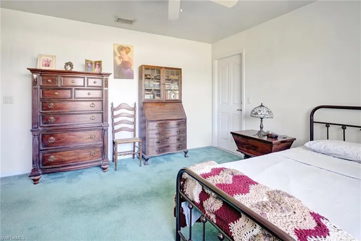 Bedroom featuring light carpet and ceiling fan