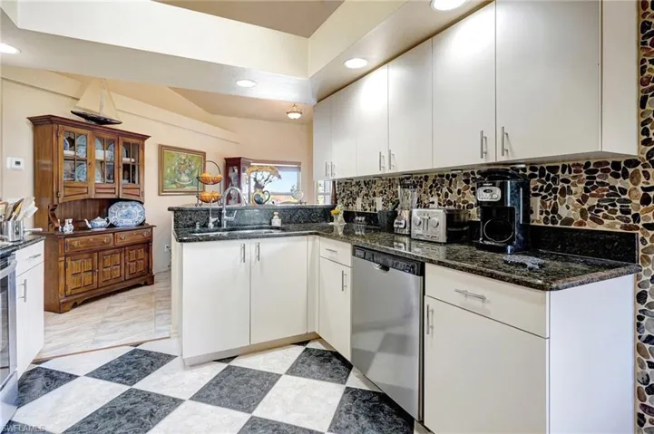 Kitchen with dishwasher, white cabinets and kitchen peninsula