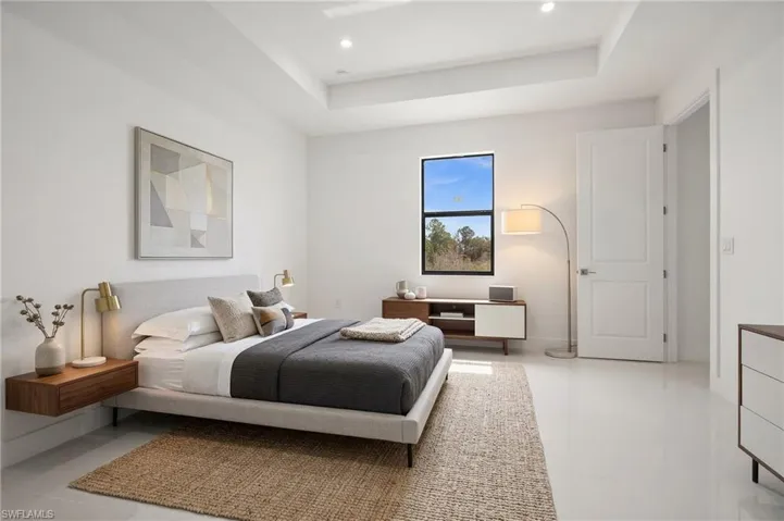 Bedroom featuring a raised ceiling