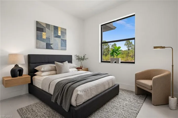 Bedroom featuring baseboards and light tile patterned flooring