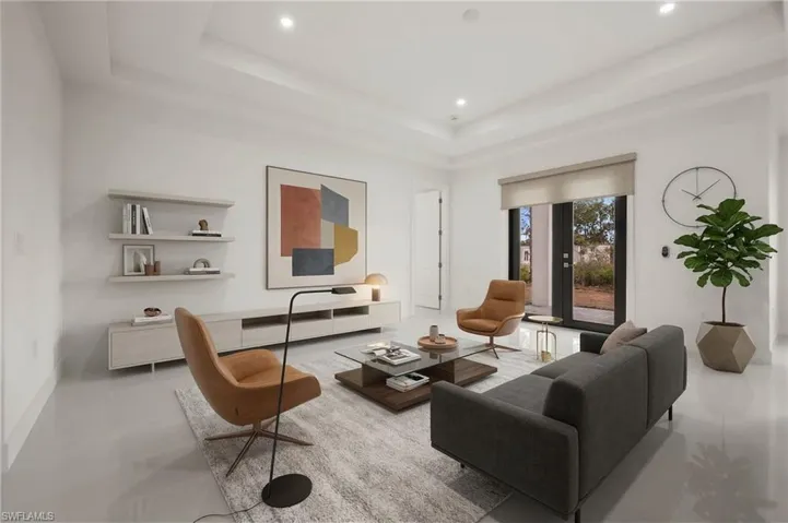 Living room with recessed lighting and a tray ceiling