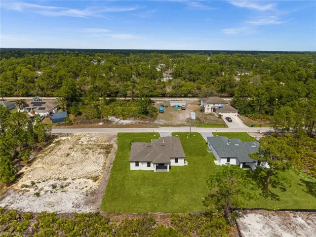 Aerial view of residential area with a heavily wooded area