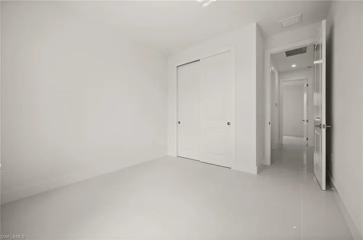 Unfurnished bedroom featuring light tile patterned floors and a closet