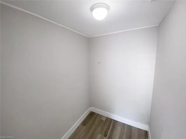 Spare room with hardwood / wood-style flooring and a textured ceiling