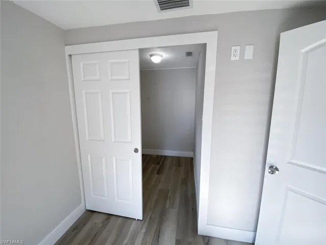 Unfurnished bedroom featuring wood-type flooring and a closet