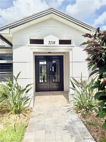 Doorway to property with french doors and stucco siding
