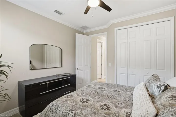 Bedroom featuring crown molding, a closet, and ceiling fan
