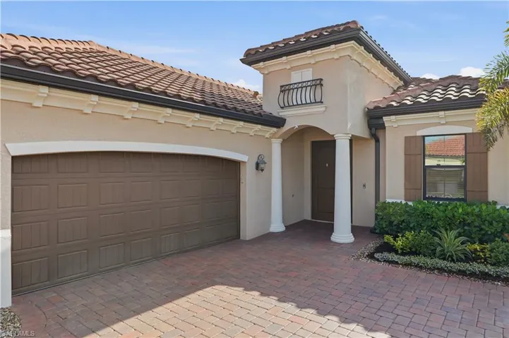 Mediterranean / spanish-style home featuring decorative driveway, stucco siding, a tile roof, an attached garage, and a balcony