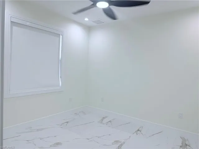 Spare room with a ceiling fan, marble finish flooring, and recessed lighting
