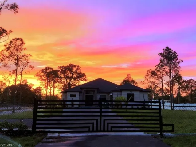 View of front of house featuring a fenced front yard and a gate