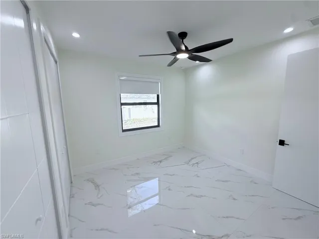Unfurnished bedroom featuring a ceiling fan, light marble finish flooring, and recessed lighting
