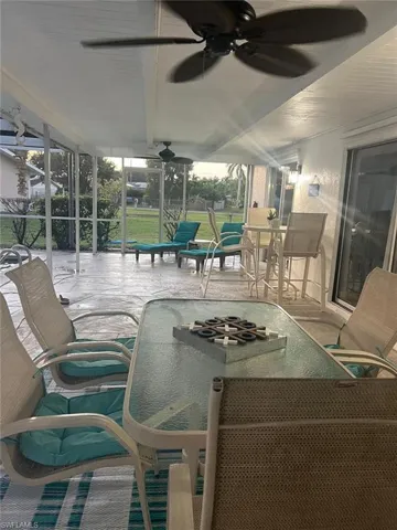 Sunroom / solarium featuring ceiling fan