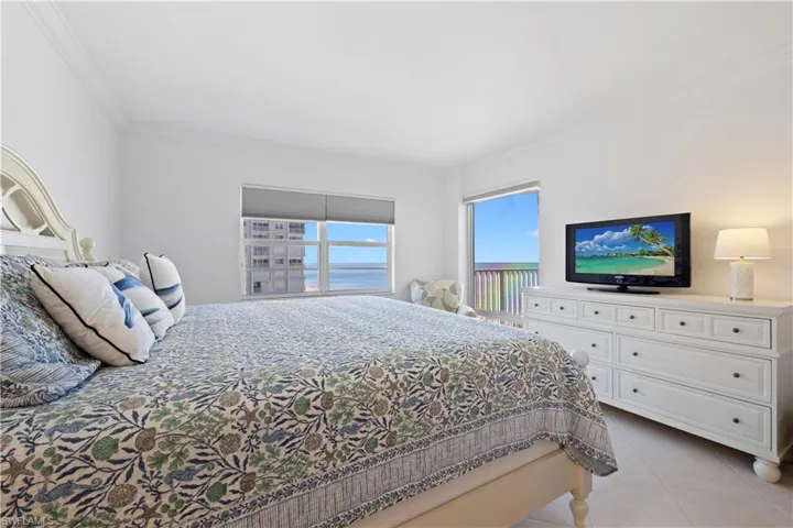Bedroom featuring crown molding and light tile patterned floors