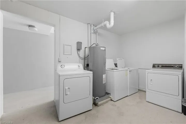 Laundry room with washer and clothes dryer and water heater