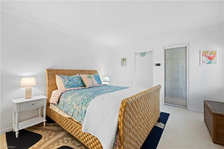 Bedroom featuring crown molding and light tile patterned floors