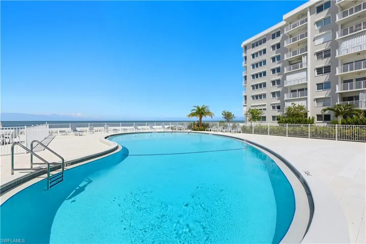 Community pool with a patio