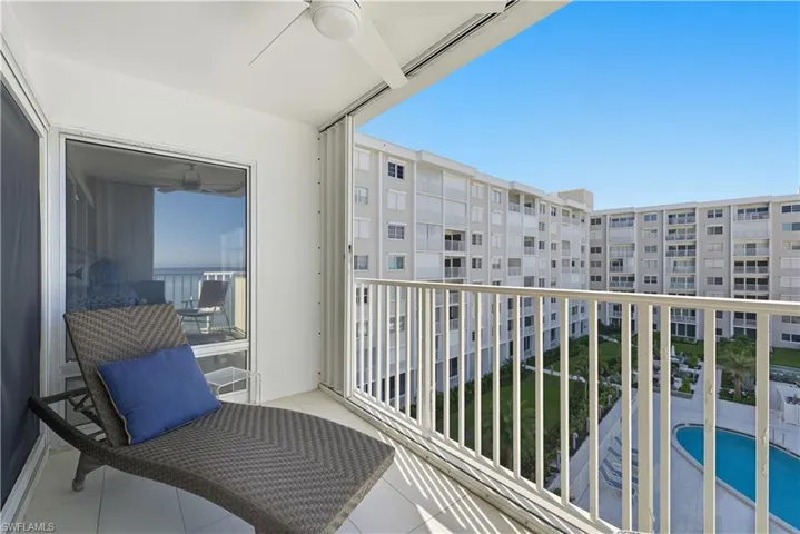 Balcony with ceiling fan and view of pool area
