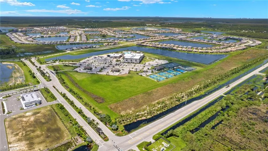Birds eye view of property with a water view