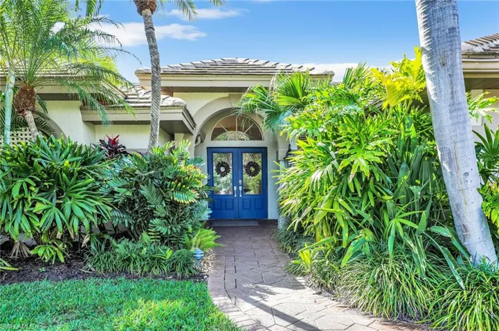 Front door w/ lush landscaping