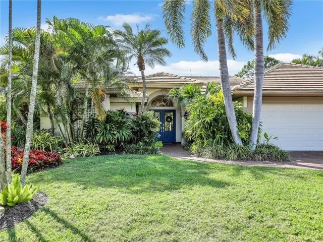 Front of the home w/ lush landscaping