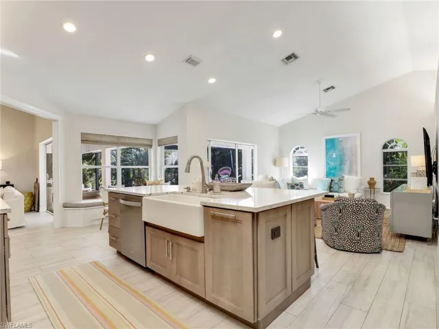 Great room with kitchen, dining & living areas w/ sliders to the lanai