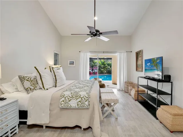 Primary suite with vaulted ceilings & sliders to the lanai