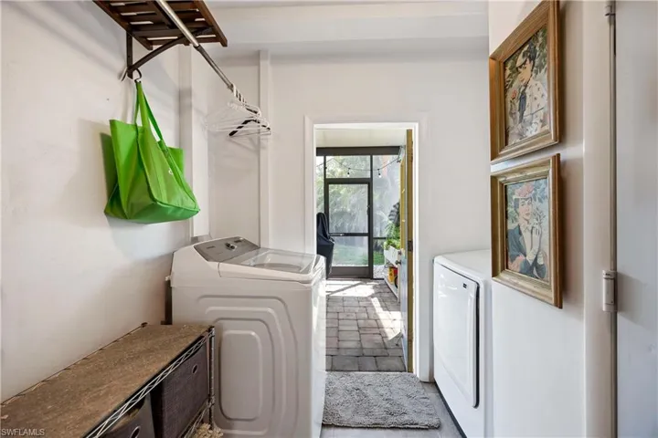 Clothes washing area featuring laundry area and washer and dryer