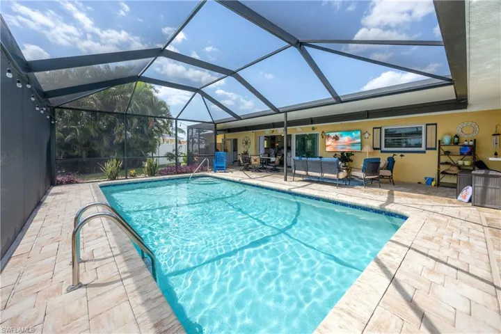 Pool with a lanai, an outdoor hangout area, and a patio area