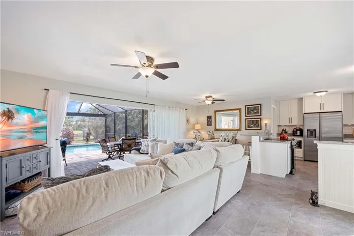 Living room with a sunroom and a ceiling fan
