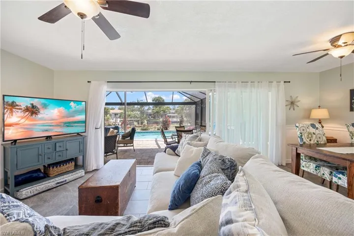 Living area with a ceiling fan and a sunroom