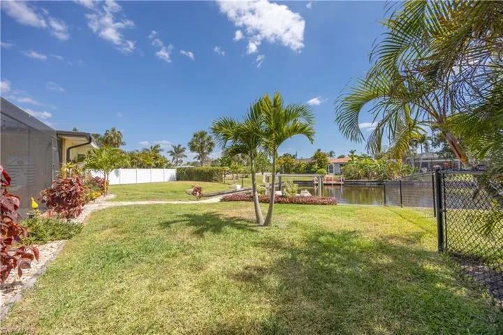 View of yard with fence and a water view