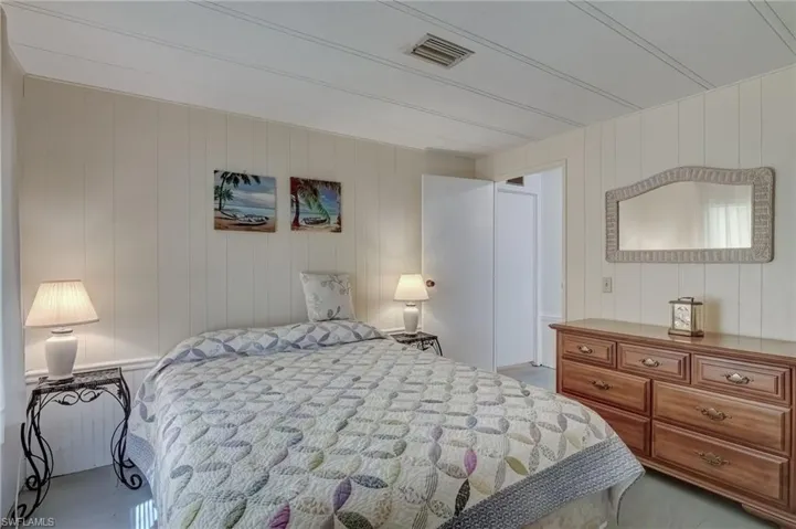 Bedroom featuring wood walls