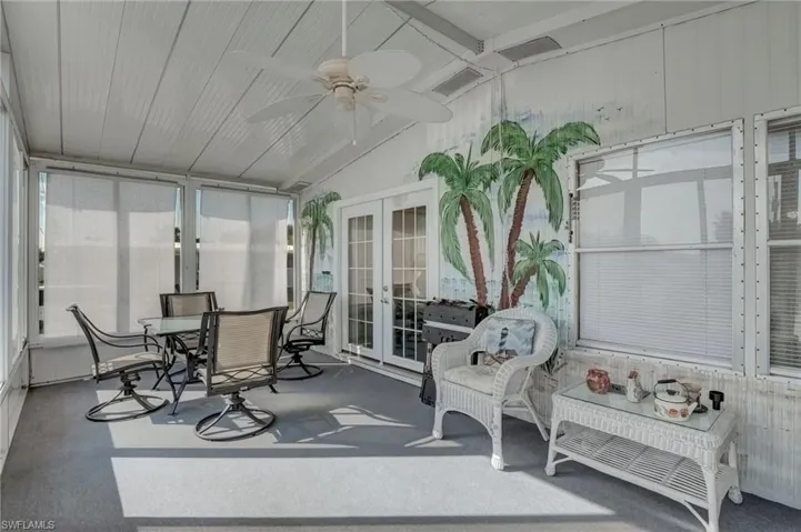 Sunroom with french doors, lofted ceiling, ceiling fan, and outdoor dining area