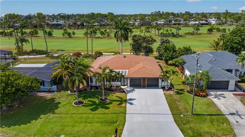 Ranch-style residence featuring a prominent golf course backdrop