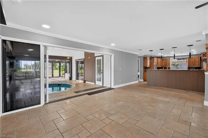 Spacious interior with tile flooring and crown molding