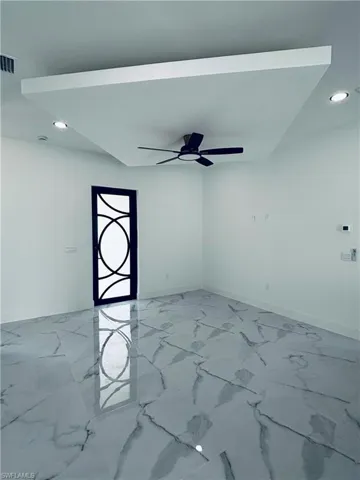 Spare room with recessed lighting, light marble finish floors, and ceiling fan