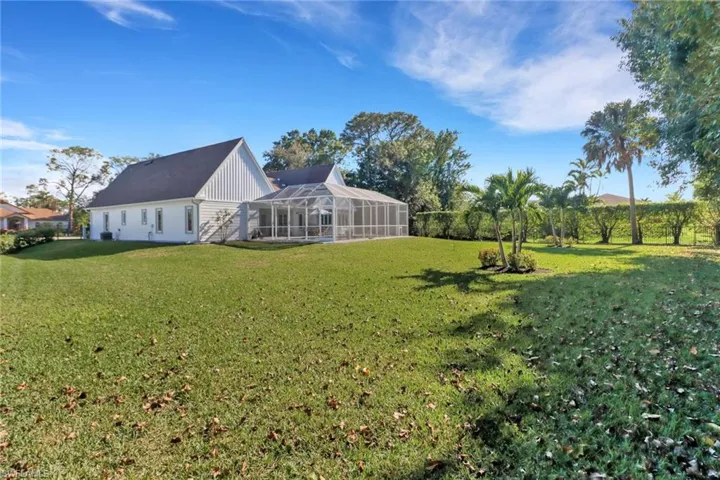 View of yard featuring glass enclosure