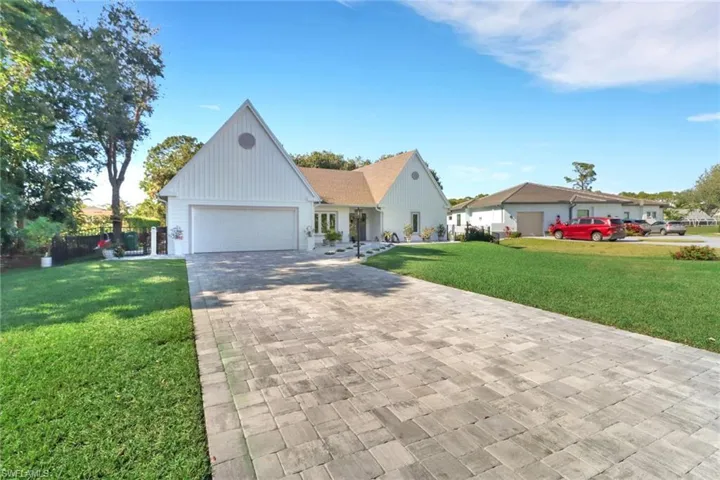 Modern farmhouse style home featuring a front yard and a garage