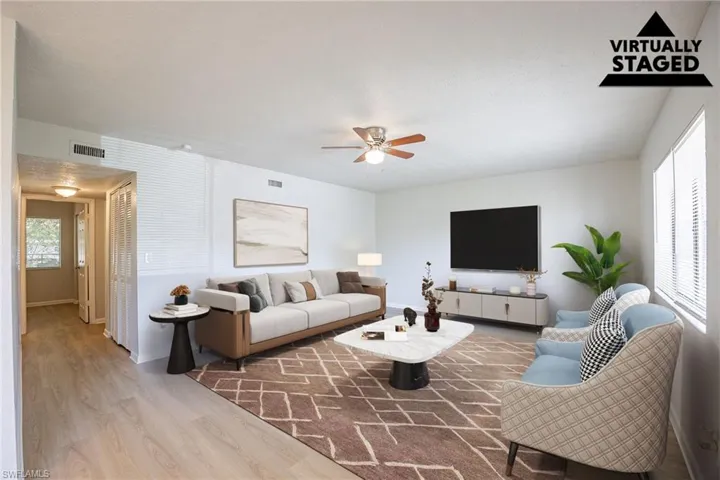 Living area featuring wood finished floors and a ceiling fan