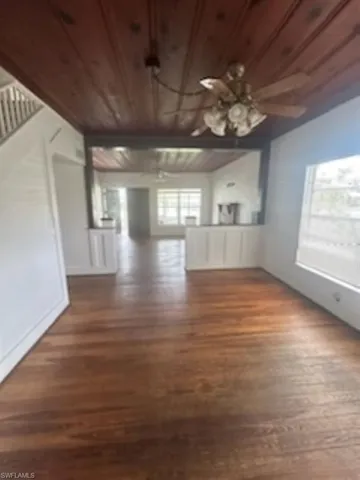Unfurnished living room featuring wood finished floors and wooden ceiling