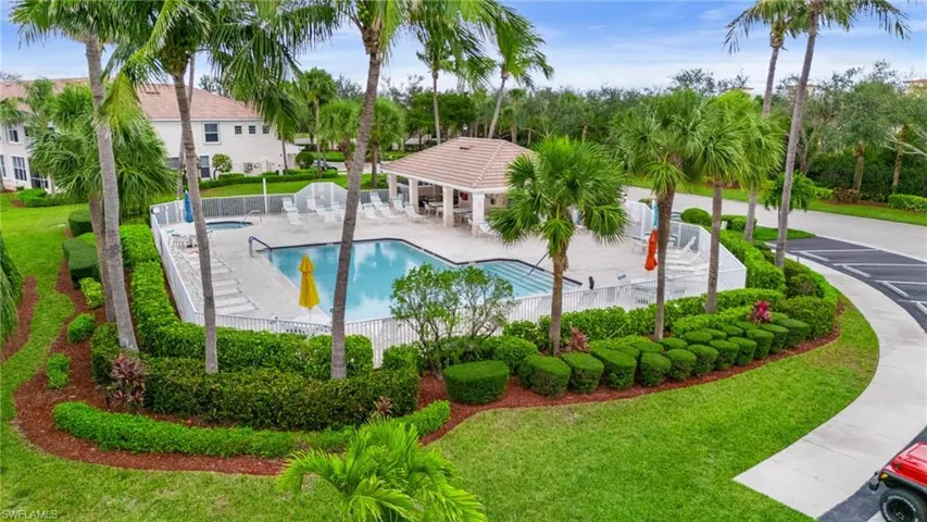 Pool featuring a patio, a lawn, and fence