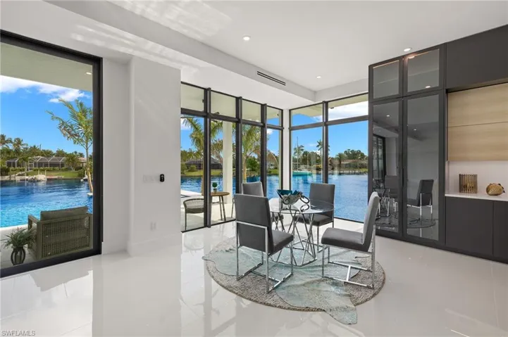 Dining area with a wall of windows and a water view