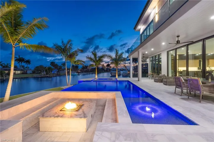 Pool at dusk with a fire pit