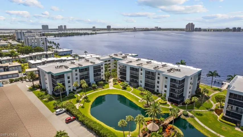 View of urban area featuring apartment complex and a nearby body of water