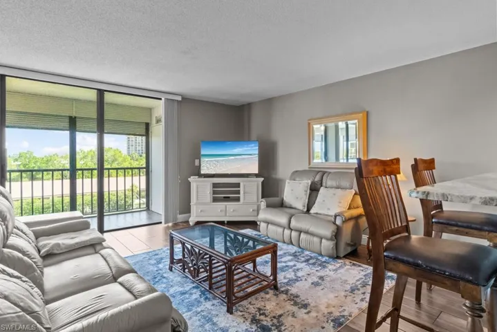 Living area featuring wood finished floors and a textured ceiling