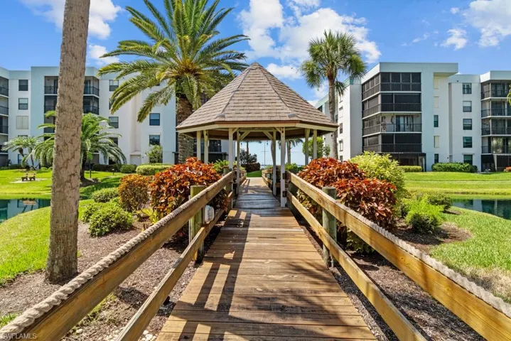 Kitchen with white appliances, decorative backsplash, white cabinets, dark wood-style flooring, and recessed lighting