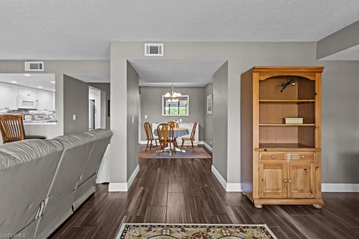 Office with wood finished floors, a textured ceiling, and ceiling fan