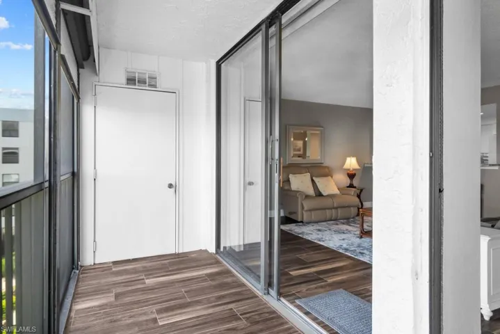 Bathroom featuring vanity, shower / bathtub combination with curtain, and wood finished floors