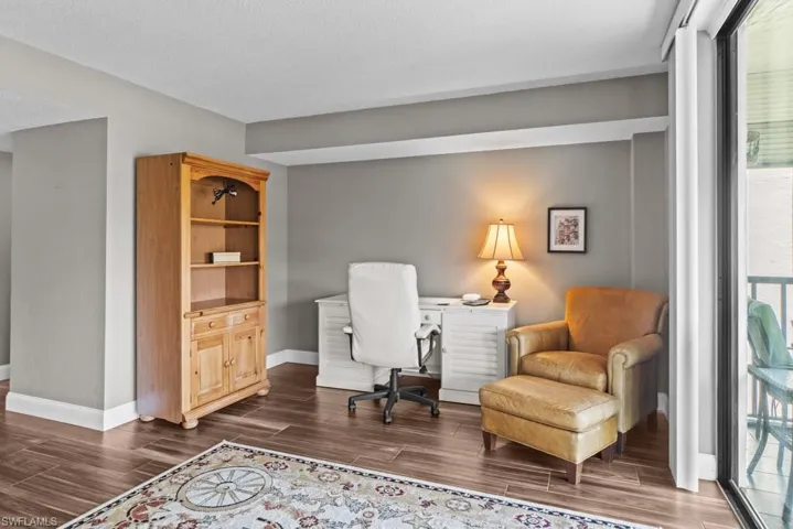 Entryway with a ceiling fan, wood finished floors, and a textured ceiling